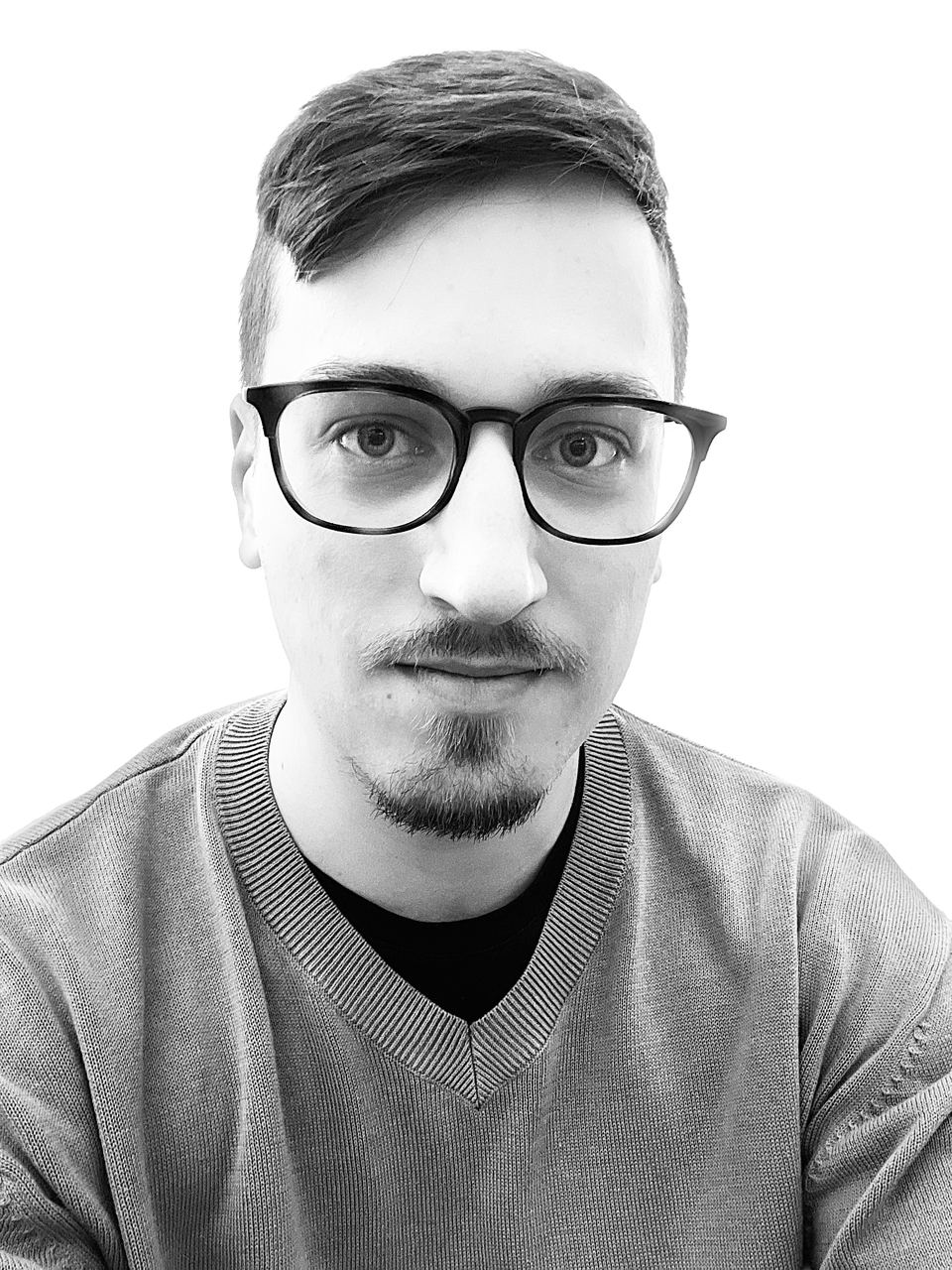 Black and white portrait of Matej Holek in glasses