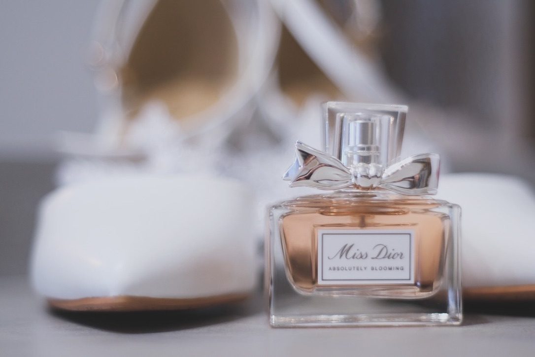 Wedding shoes and a perfume bottle