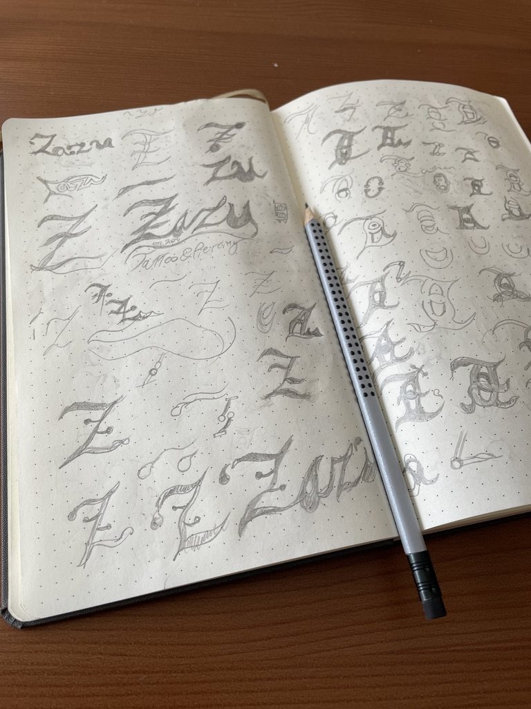 Sketchbook pages full of Z letterforms with a pencil